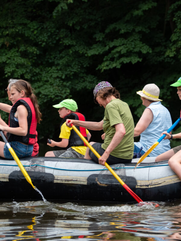 Junge Naturwächter paddeln in einem Schlauchboot durch den Fluss